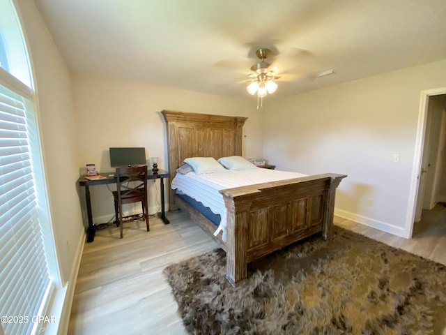 bedroom with light hardwood / wood-style floors and ceiling fan