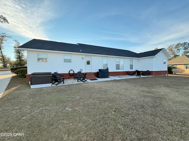 back of property featuring a patio area, a jacuzzi, and a yard