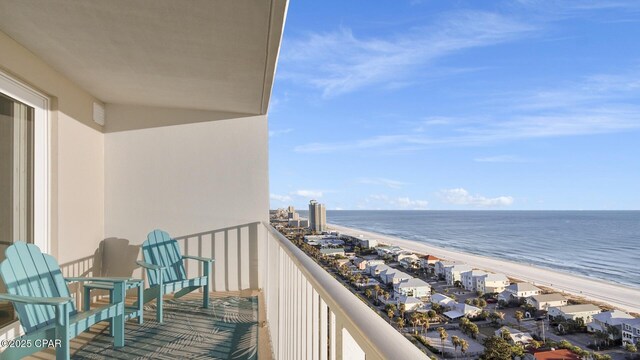 balcony featuring a beach view and a water view