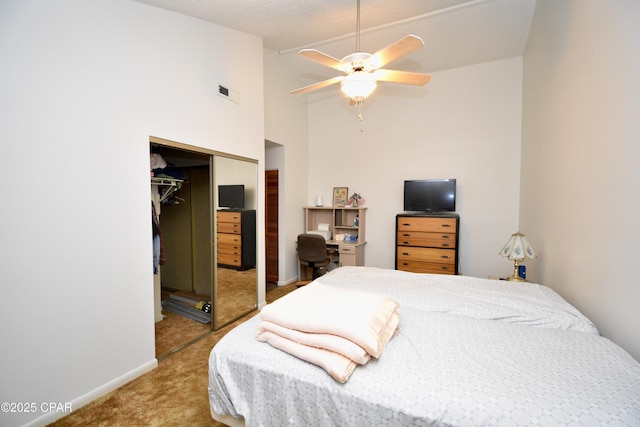 bedroom featuring a closet, ceiling fan, vaulted ceiling, and light colored carpet