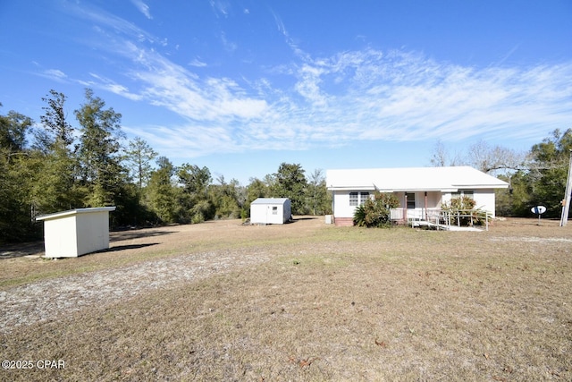 view of yard featuring covered porch and a storage shed