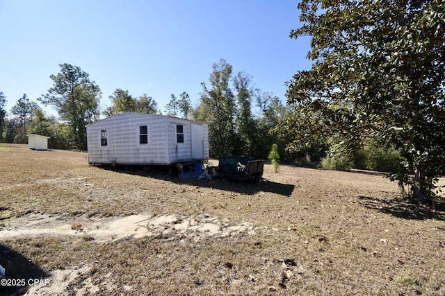 view of side of home with an outdoor structure