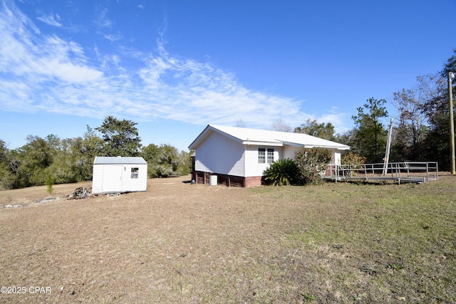 view of property exterior featuring a storage unit and a yard