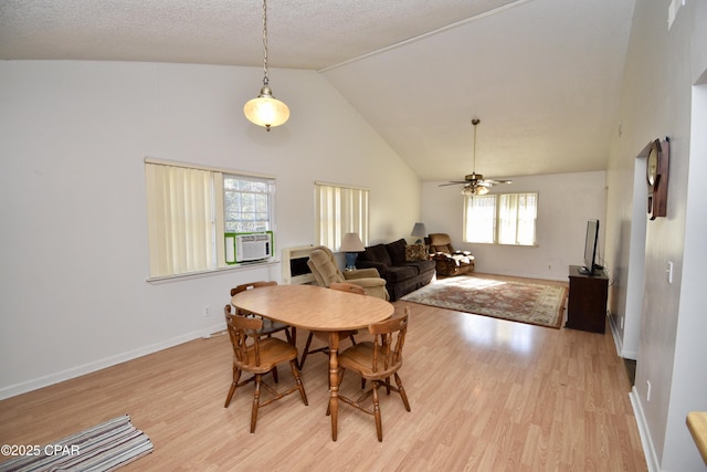 dining space with a healthy amount of sunlight, ceiling fan, light hardwood / wood-style floors, and cooling unit