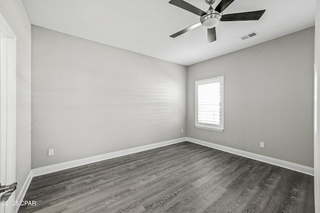 spare room featuring ceiling fan and dark wood-type flooring