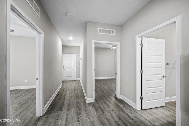 hallway with dark hardwood / wood-style floors