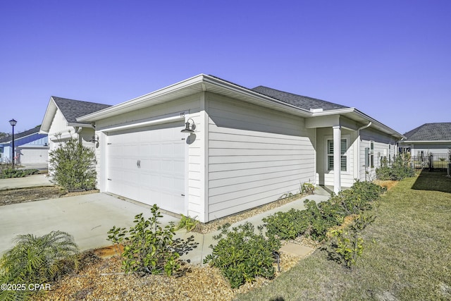 view of property exterior with a yard and a garage