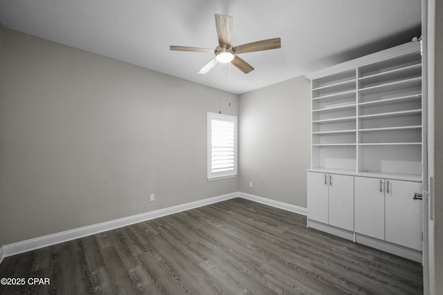 spare room with dark hardwood / wood-style flooring and ceiling fan