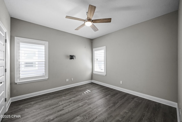 spare room featuring ceiling fan and dark wood-type flooring