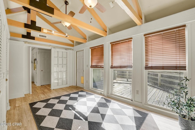 unfurnished room featuring ceiling fan, high vaulted ceiling, beamed ceiling, and light hardwood / wood-style floors