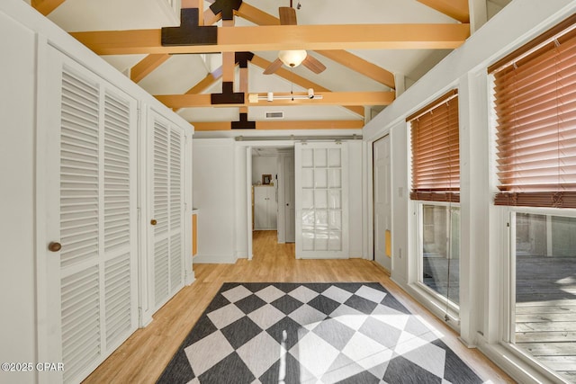 interior space with a wealth of natural light and lofted ceiling with beams