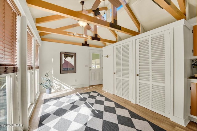 bedroom featuring hardwood / wood-style flooring and lofted ceiling with beams