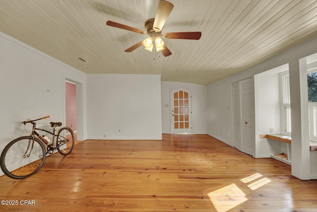 interior space with light wood-type flooring, wooden ceiling, ornamental molding, and ceiling fan