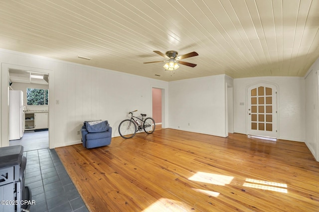 tiled empty room with ceiling fan and wooden ceiling