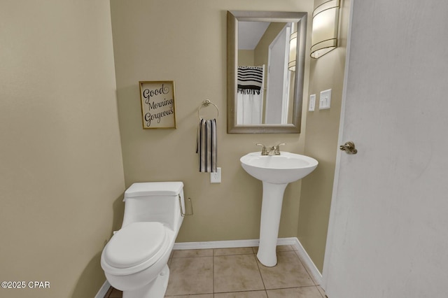 bathroom featuring toilet and tile patterned flooring