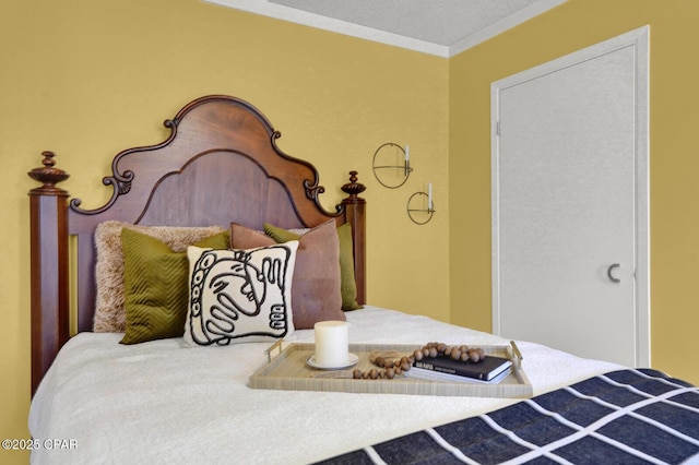 bedroom featuring a textured ceiling and crown molding