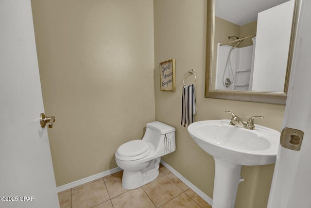 bathroom with sink, toilet, walk in shower, and tile patterned flooring