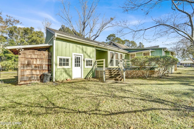 back of house featuring a lawn