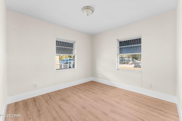 unfurnished room with light hardwood / wood-style floors