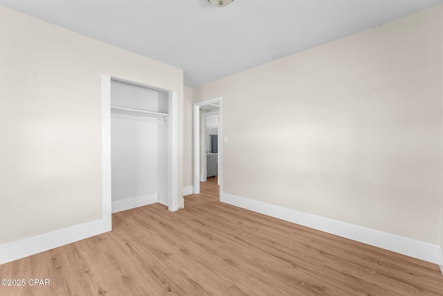 unfurnished bedroom featuring a closet and light hardwood / wood-style flooring