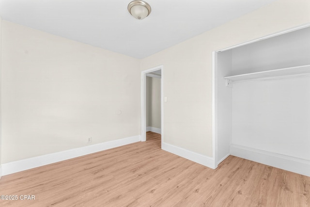 unfurnished bedroom featuring a closet and light hardwood / wood-style flooring