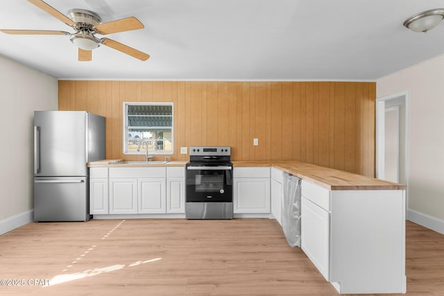 kitchen featuring sink, ceiling fan, light wood-type flooring, white cabinetry, and stainless steel appliances