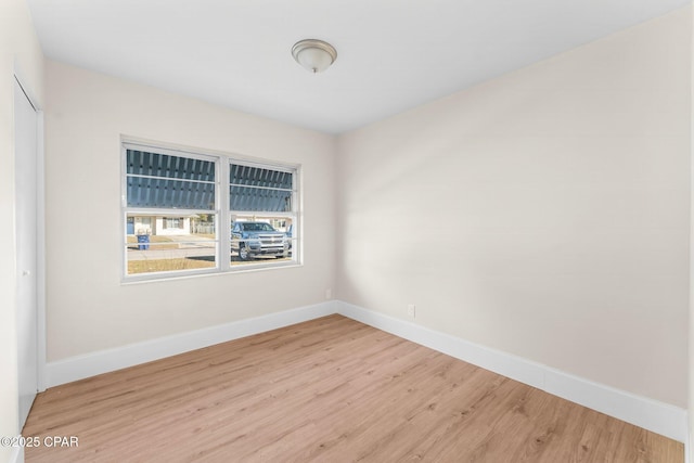 unfurnished room with hardwood / wood-style flooring