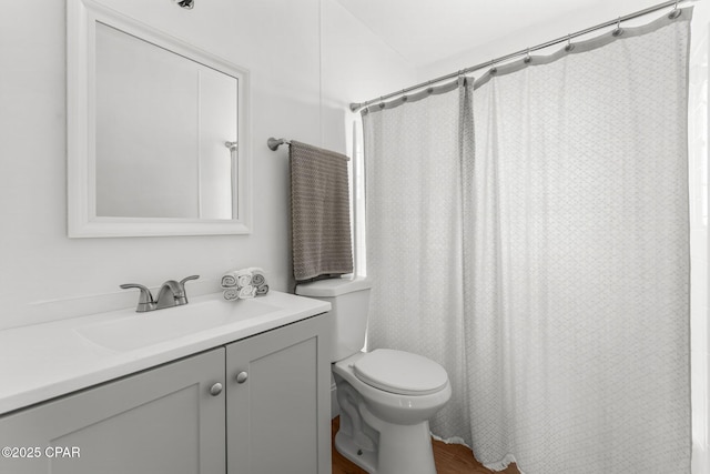 bathroom with a shower with curtain, vanity, and toilet