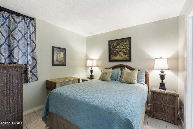 bedroom with light tile patterned floors and a textured ceiling