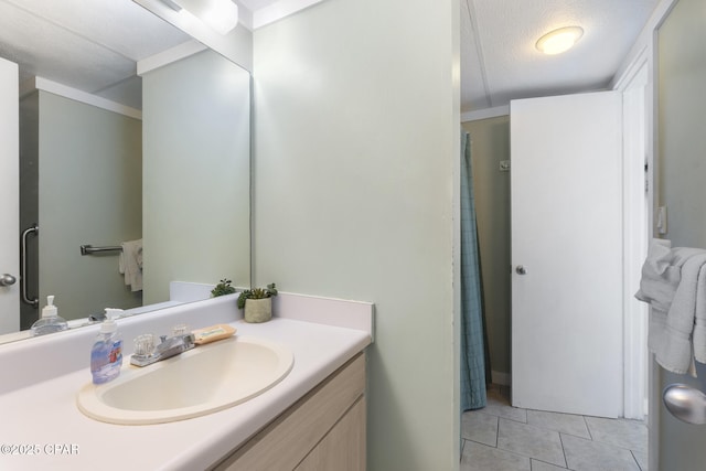 bathroom featuring vanity, tile patterned floors, and a textured ceiling