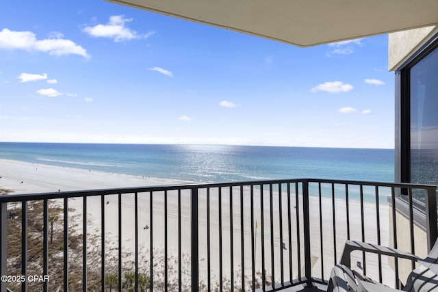 balcony with a water view and a beach view