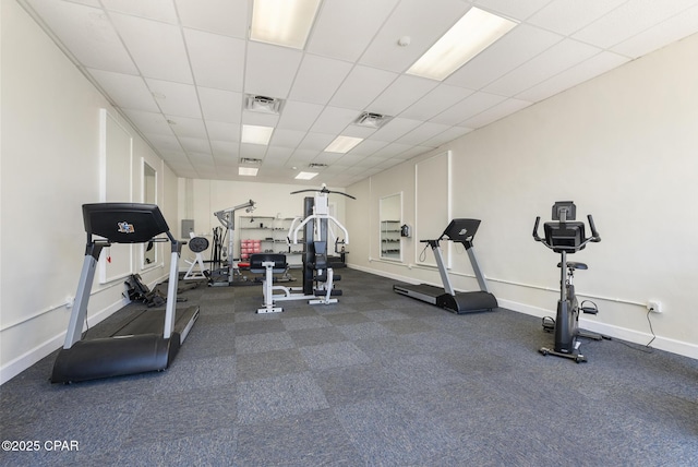 workout room with a paneled ceiling