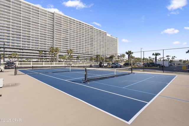 view of tennis court with basketball hoop