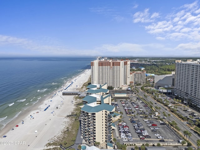 bird's eye view featuring a water view and a beach view