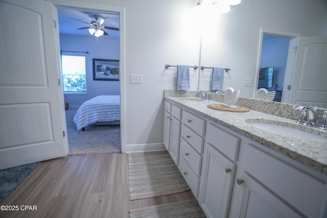 bathroom featuring vanity, ceiling fan, and wood-type flooring