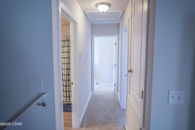 hall with light colored carpet