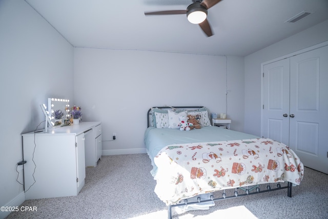 carpeted bedroom featuring a closet and ceiling fan