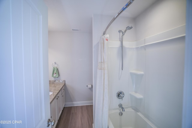 bathroom featuring hardwood / wood-style flooring, vanity, and shower / tub combo with curtain