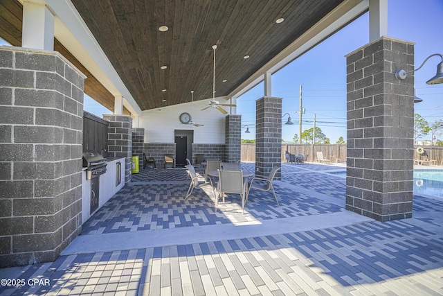 view of patio / terrace with a fenced in pool, area for grilling, and ceiling fan