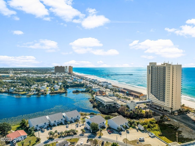 drone / aerial view featuring a beach view and a water view