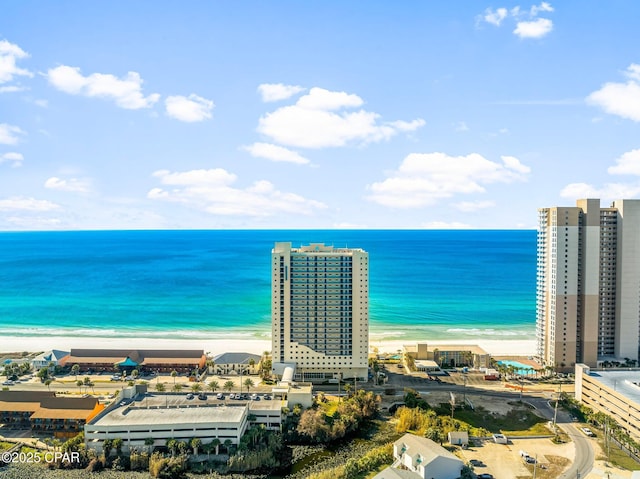 birds eye view of property featuring a beach view and a water view