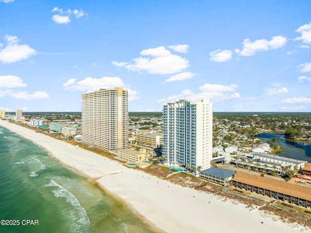 birds eye view of property with a water view, a view of city, and a beach view