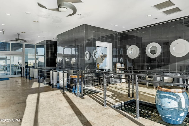 interior space with recessed lighting, a ceiling fan, and expansive windows