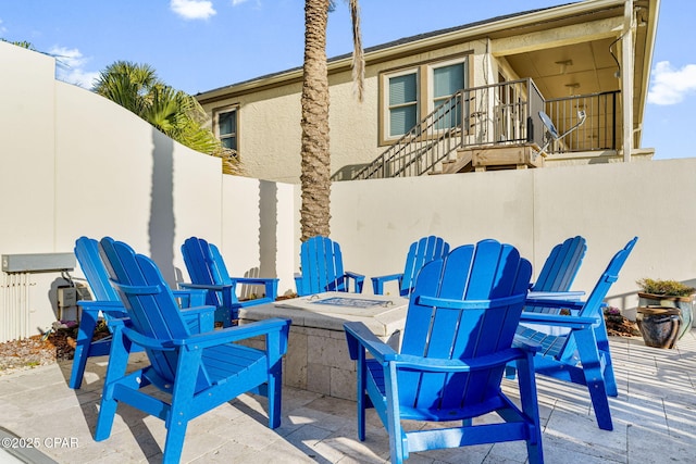 view of patio featuring a fire pit and fence