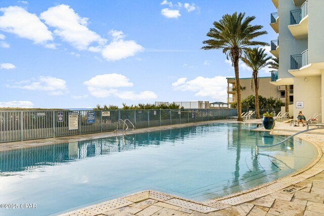 pool featuring a patio and fence