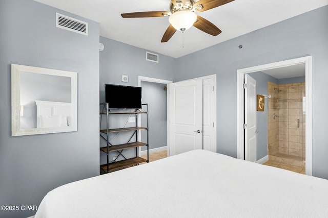 tiled bedroom featuring baseboards, visible vents, and ensuite bathroom