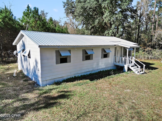 view of side of home featuring a yard