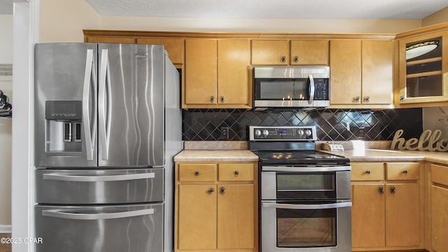 kitchen with backsplash and stainless steel appliances