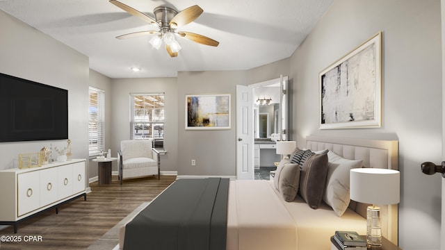 bedroom with dark wood-style flooring, connected bathroom, baseboards, and ceiling fan