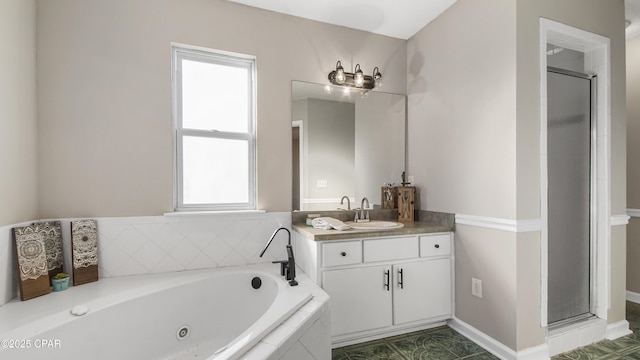 bathroom featuring a jetted tub, a shower stall, and vanity